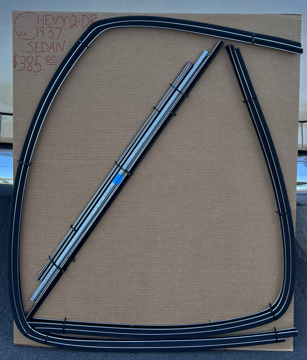 1937 Chevy two-door sedan window channel kit with formed run channels and straight components arranged on a cardboard board