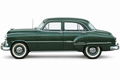 Side view of a green 1951 Chevrolet Styleline Deluxe four-door sedan on a white background.