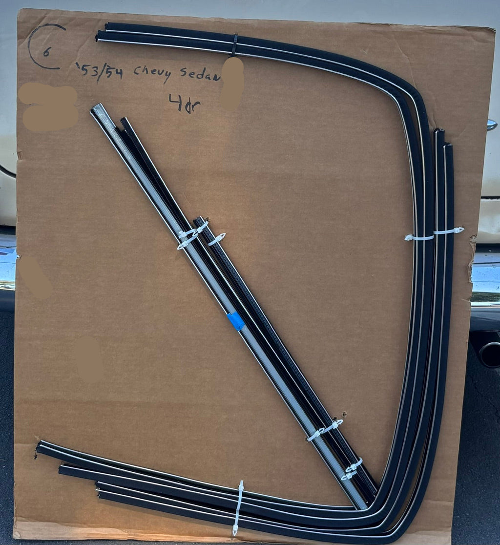  1953–1954 Chevy four-door sedan window channel kit with formed run channels and straight components arranged on a cardboard board.