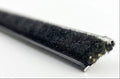 Close-up of a straight belt line window sweep showing the black fuzzy pile and cut end.