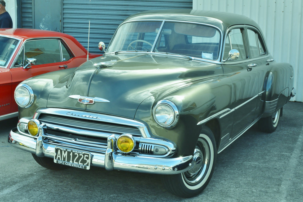 Green Chevrolet Styleline Deluxe four-door sedan viewed from the front and driver’s side.